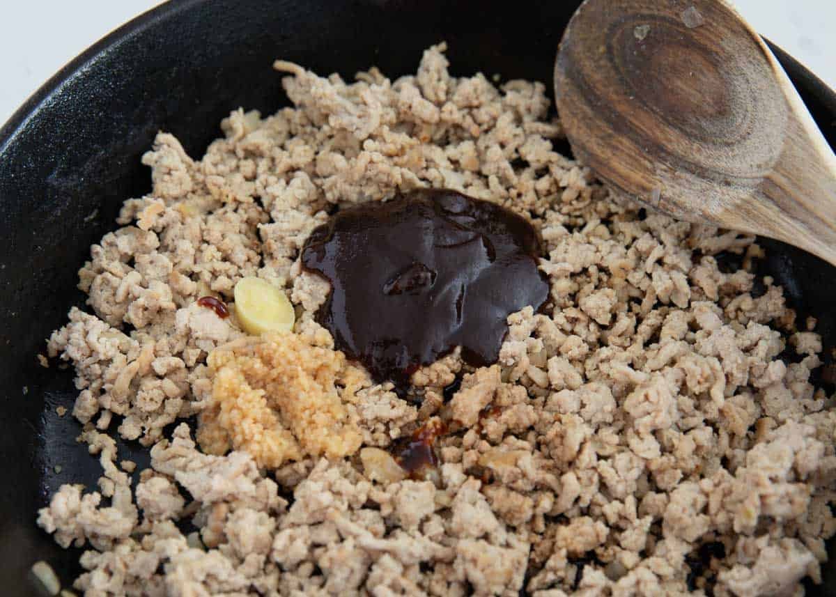 Cooking ground chicken and onion in a skillet for PF chang's lettuce wraps.