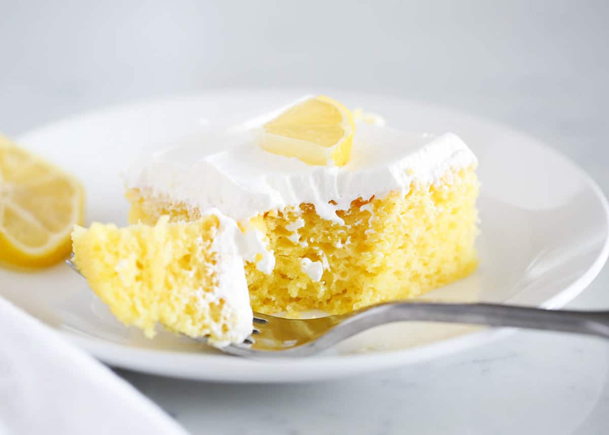 Lemon poke cake on a plate.