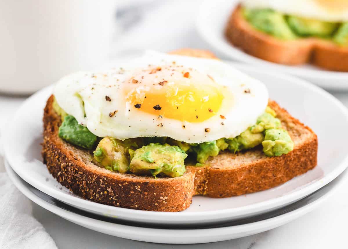 Sunny side up eggs on avocado toast.