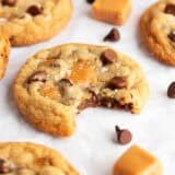 Caramel chocolate chip cookies with a bite taken.