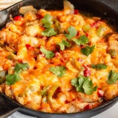 Cheesy chicken fajita casserole in a skillet.