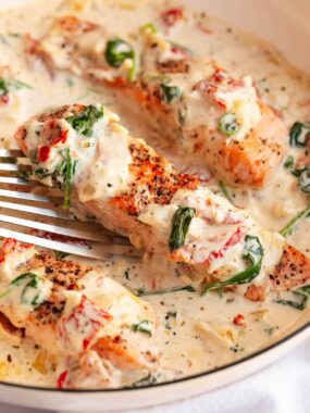 Tuscan salmon in a skillet.