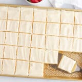 Sliced white Texas sheet cake.