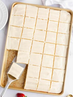 Sliced White texas sheet cake topped with a smooth, crackly almond glaze.