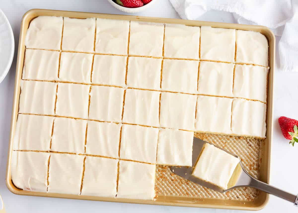 Sliced white Texas sheet cake.