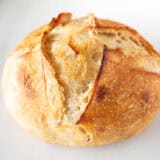 Sourdough bread loaf on marble counter.