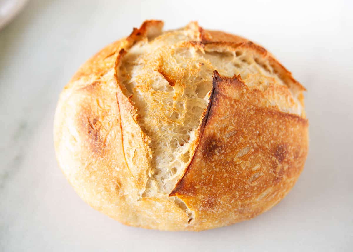 Sourdough bread loaf on marble counter.