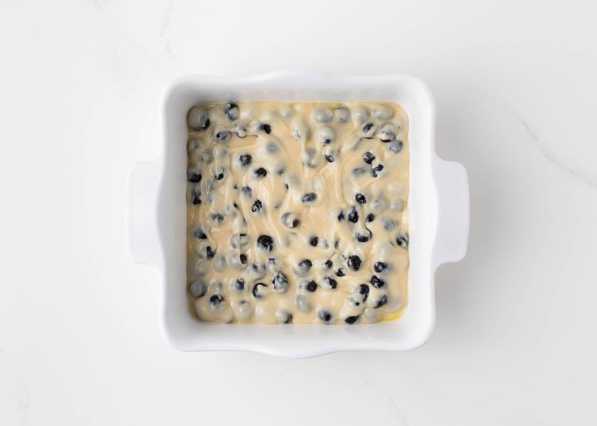 Blueberry coffee cake batter in a baking dish.