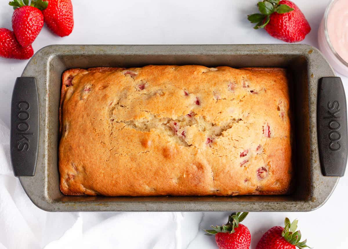 Freshly baked strawberry quick bread in a loaf pan.