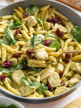 Chicken pesto pasta in a large skillet.