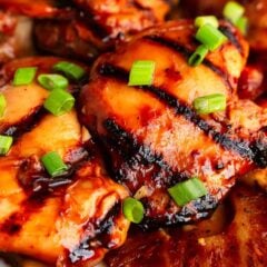 Close-up of caramelized Huli Huli chicken thighs with a sticky pineapple-soy glaze.