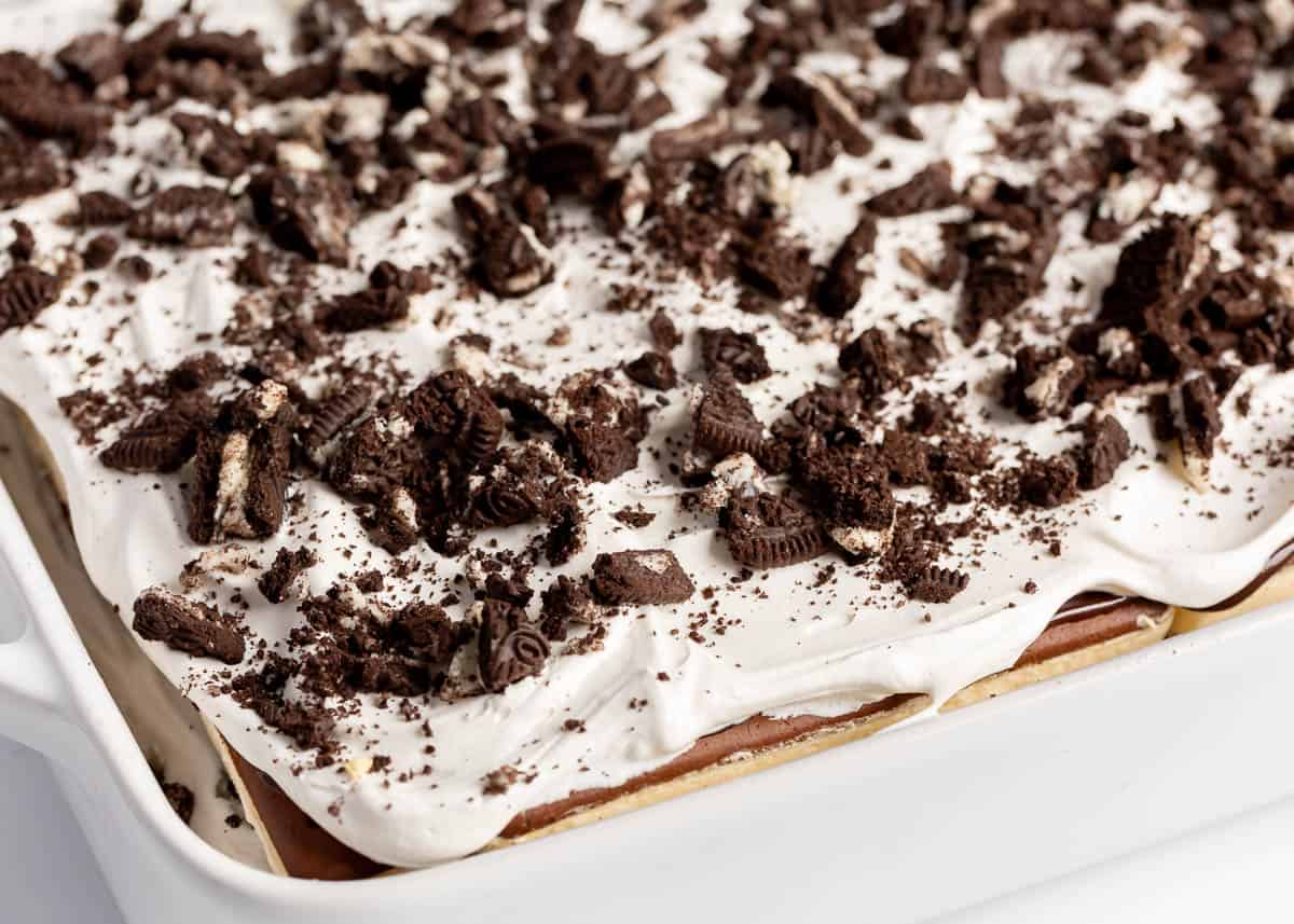 Assembled ice cream sandwich cake in a white pan.