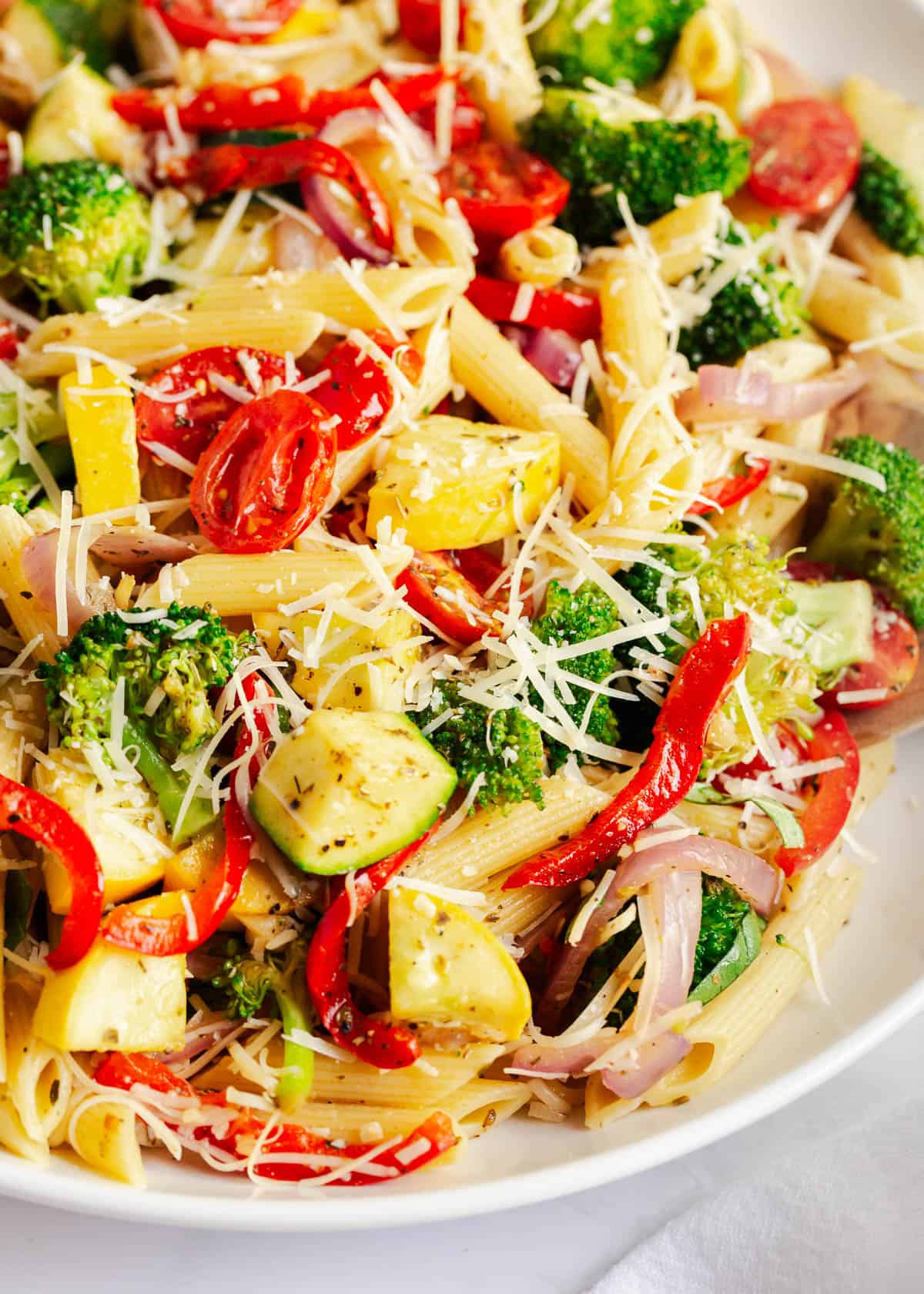 This 30-minute pasta primavera is bold in color and flavor! It's an easy, fresh, and delicious pasta dish with loads of veggies tossed in a light lemon Parmesan sauce. A close up photo of pasta primavera. .