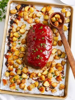 Sheet pan meatloaf with potatoes on a rimmed sheet pan.