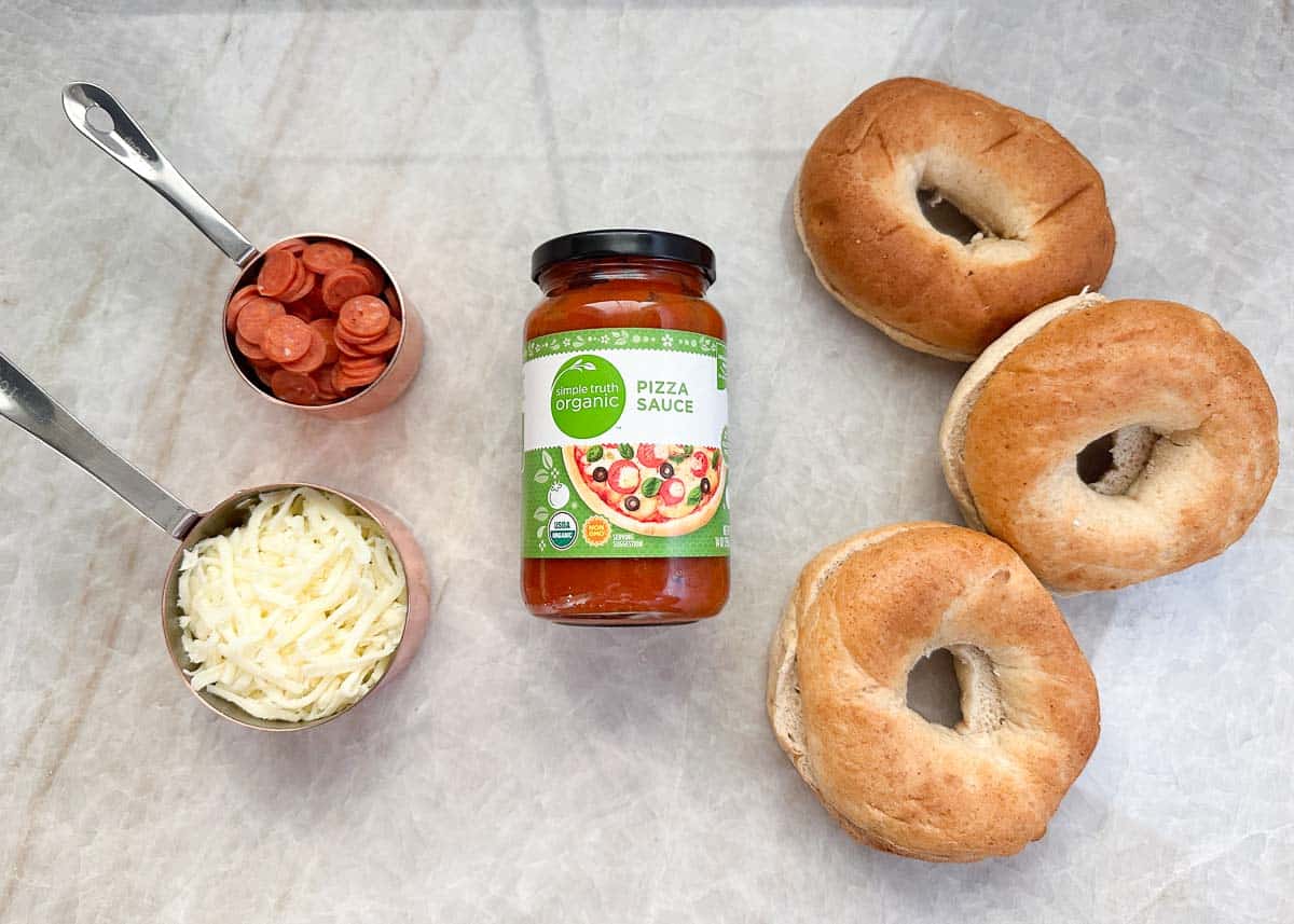 Pizza bagel ingredients on the counter.