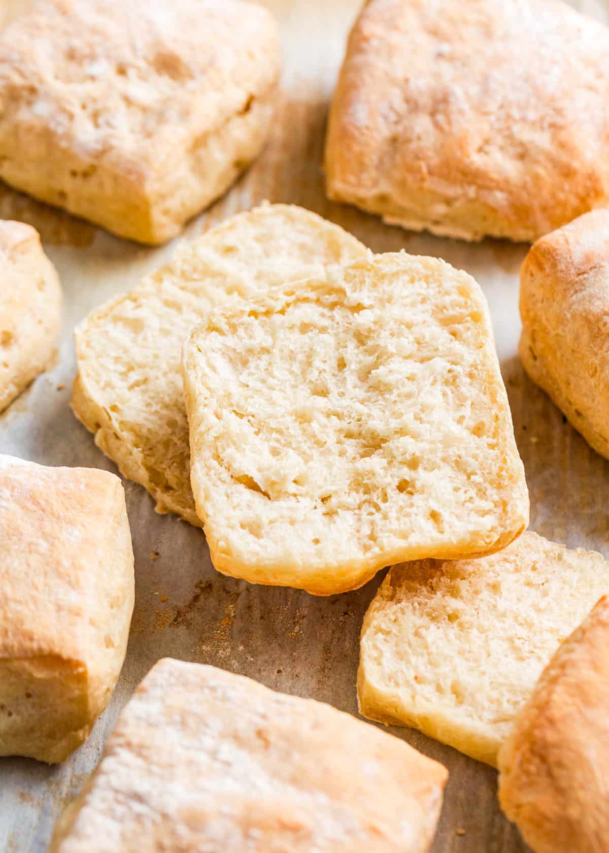 All you need is a few hours and these ciabatta rolls can be made in one day! They are light and airy on the inside with a chewy crumb and a golden crust dusted with flour. Sliced ciabatta bread rolls.