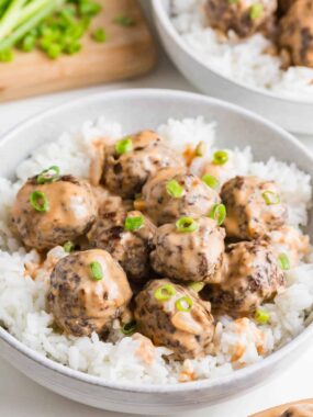 Firecracker meatballs in a bowl with rice.