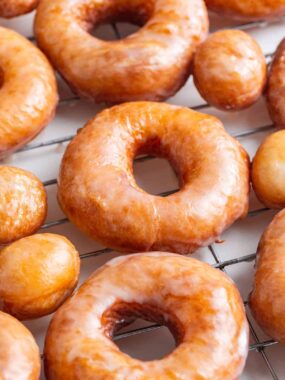 Homemade donuts on a cooling rack.