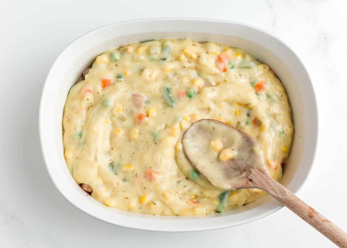Pouring sauce in baking dish.