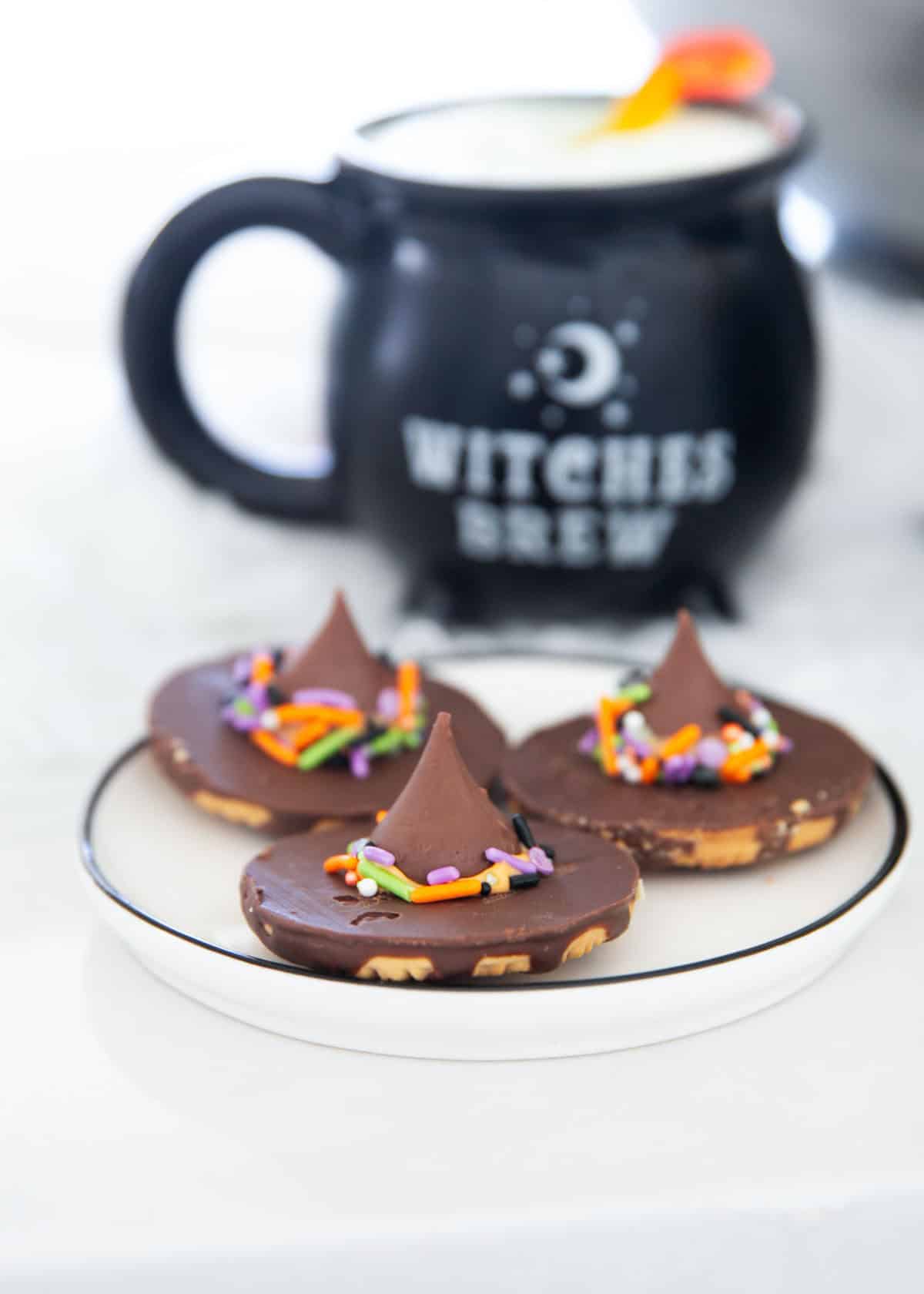 Witch hat cookie on a plate for a cute Halloween cookie option.