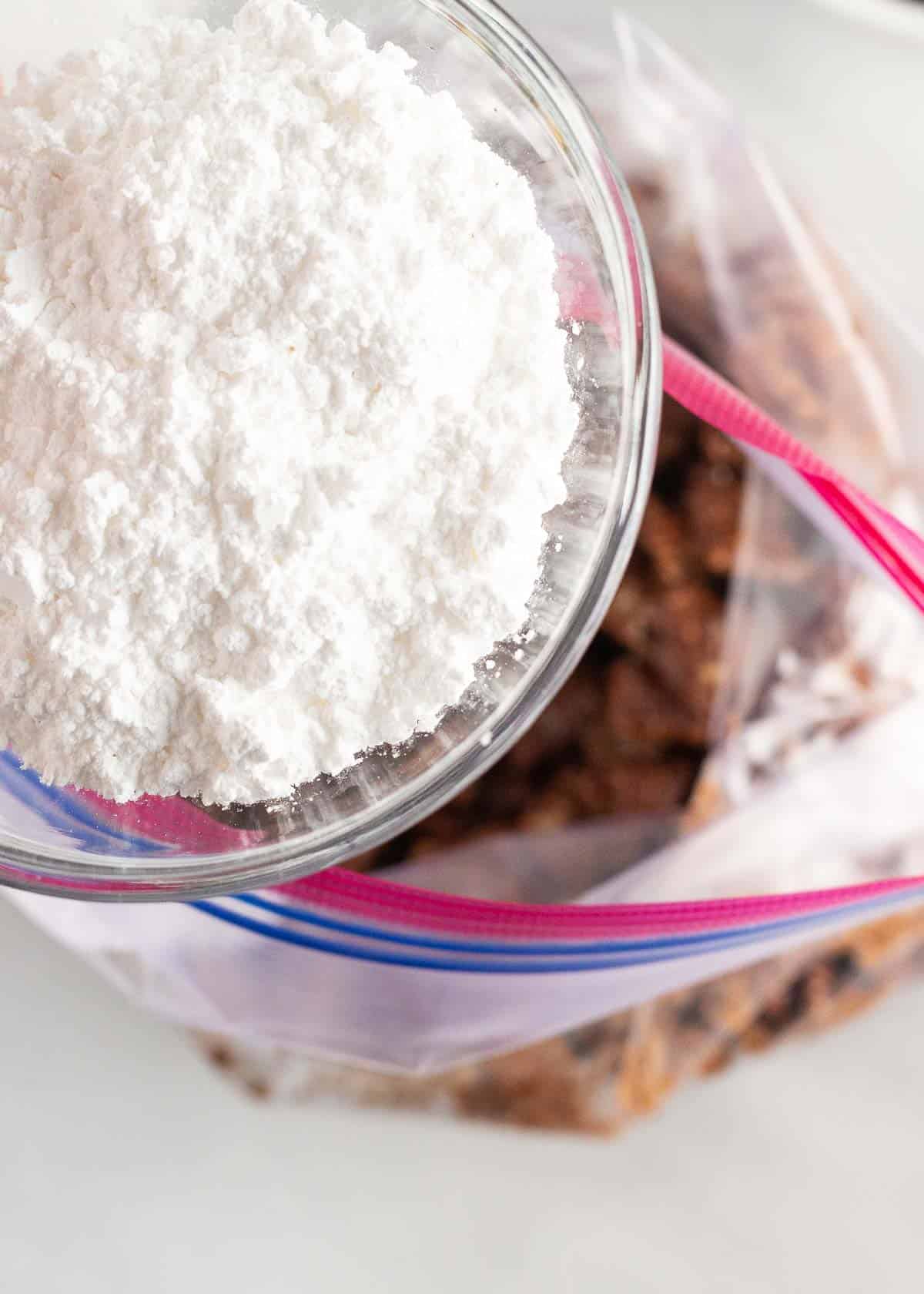 Pouring powdered sugar in puppy chow.