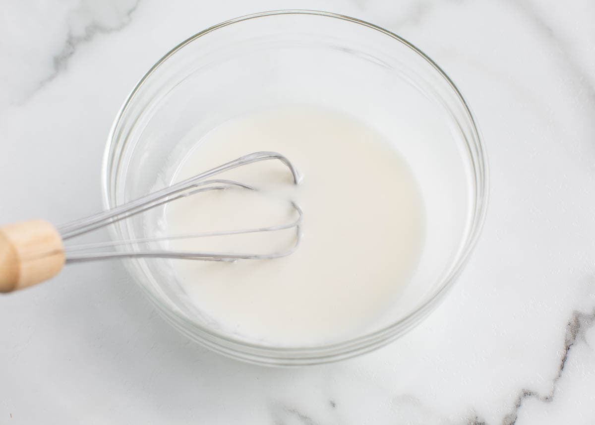 Whisking glaze in a bowl.