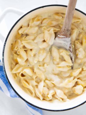 Copycat Panera mac and cheese in a pot with a creamy white cheddar sauce and pasta shells.
