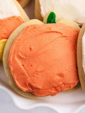 Pumpkin cut-out cookies on cake plate.