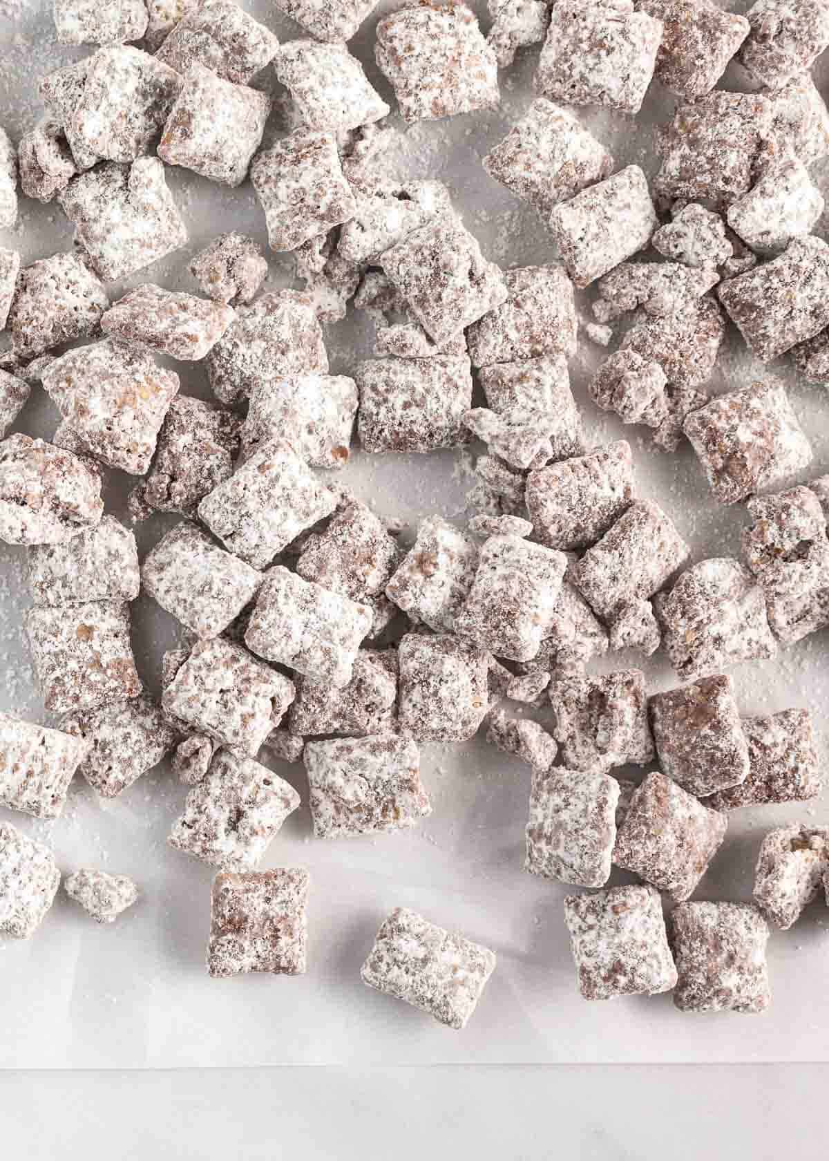 Puppy chow on a piece of parchment paper.