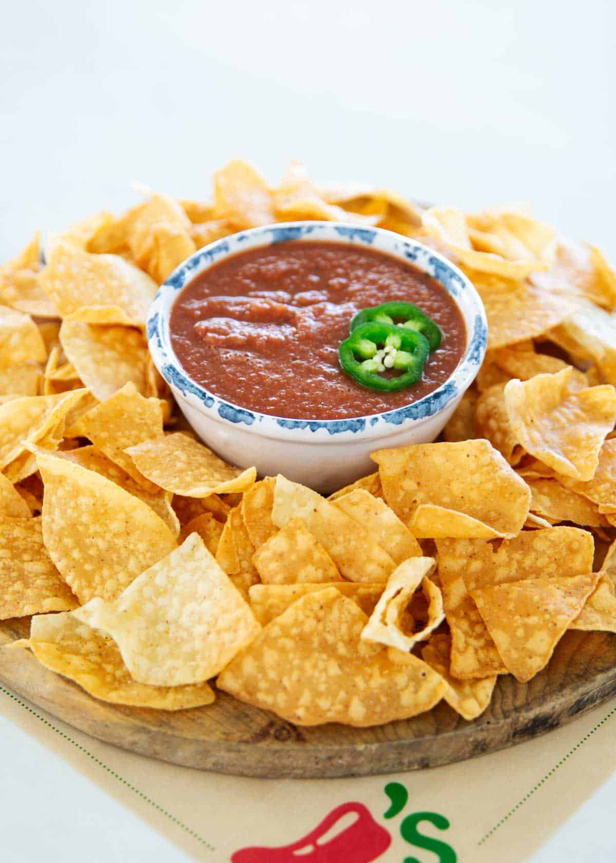 Chilis salsa and tortilla chips on a platter.