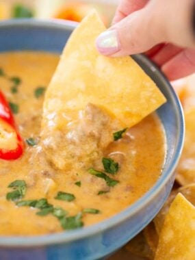Dipping chip in cottage cheese queso.