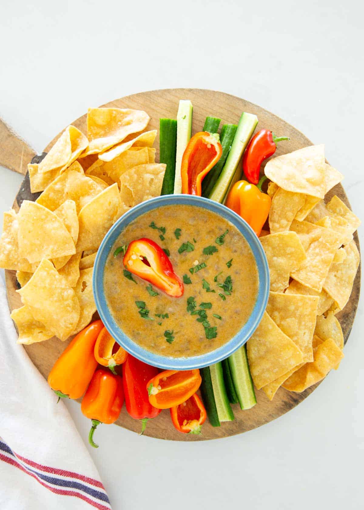 Viral TikTok cottage cheese queso is a nourishing, high protein snack that is creamy and cheesy with cottage cheese, cheese green chiles and taco seasoned ground beef. Cottage cheese queso on platter.