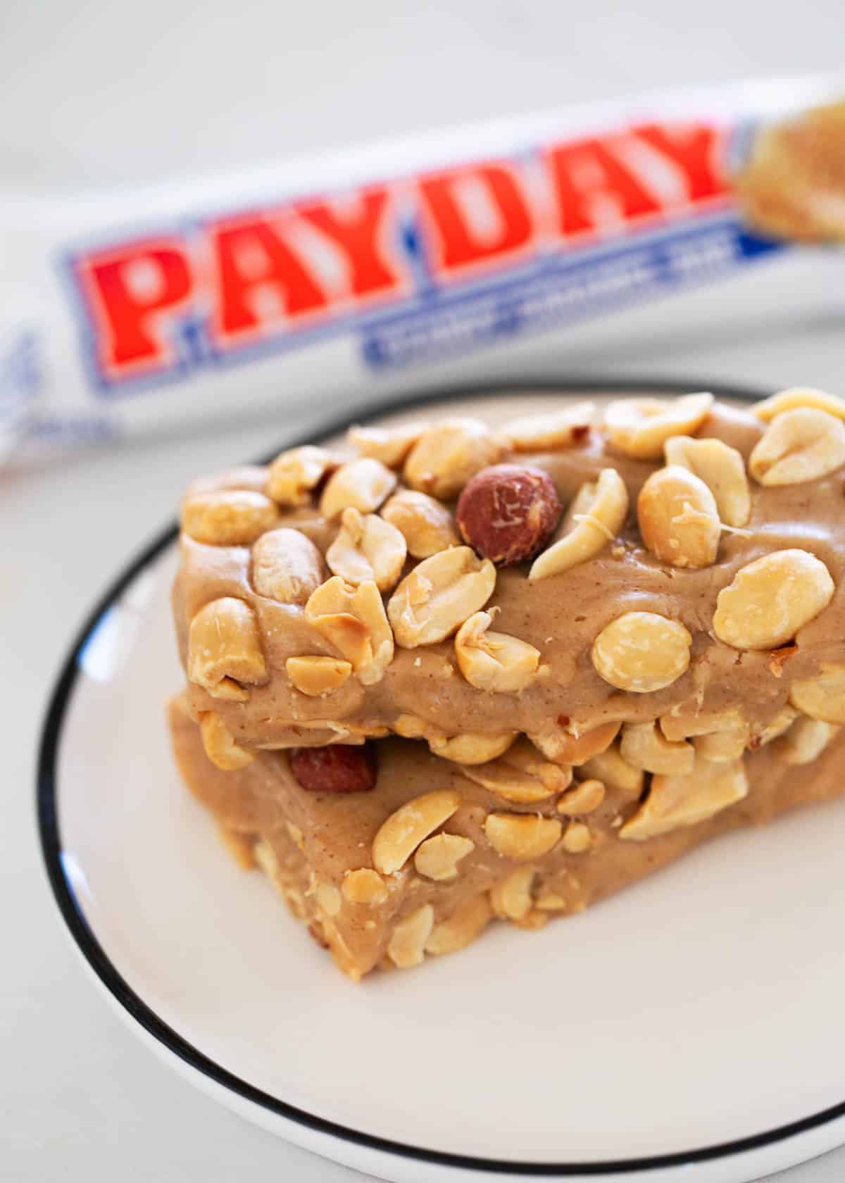 Change block type or style Move WPRM Recipe block from position 19 up to position 18 Block WPRM Recipe is at the end of the content and can’t be moved down Change alignment Homemade PayDay Candy Bars Sweet and salty homemade PayDay candy bars taste like the real deal with a chewy nougat center and salted peanuts on top. It's easy to make this candy treat at home! Need more candy recipes? Try Crunch bars, Snickers recipe or caramel candy, too! Payday candy bar on a plate. Placeholder for table of contents Why I Love This Easy Copycat Recipe Homemade is better: A store-bought candy bar is convenient but making one from scratch tastes so much better! Try Twix bars and Reese's peanut butter bars, too . Sweet and salty: Homemade PayDay candy bars are the best combination of sweet and salty taste with a chewy texture. Plus, no 'extra' ingredients from a manufactured candy bar. PayDay Candy Bar Recipe Ingredients Pay day candy bar ingredients on counter. How to Make PayDay Candy Bars This homemade version of a PayDay candy bar is a little more effort than just purchasing, but it's really worth it! Showing how to make pay day candy bar. Add 1 cup of the peanuts into the 9x13 baking dish. Spread around to cover the bottom. Melt butter and peanut butter chips in a medium pan over medium-low heat until smooth and creamy. Add sweetened condensed milk and mini marshmallows. Stir until all mixed. Pour over peanuts in baking dish. Top immediately with remaining peanuts and let cool at room temperature. Pay day candy bar on a plate. Recipe Tips Candy bar mold: If you have a candy bar mold, these PayDay candy bars really do look like the real thing. Salted roasted peanuts: This will give the PayDay candy bar a little more crunch. Size: Cute this recipe into fun size bars for a Halloween party or regular sized for a more indulgent treat! Use a 11x7 pan for a thicker bar, 9x13 for a thinner bar. Microwave: Instead of the stovetop, melt butter and chips in 30 second intervals. After the mixture is melted and smooth add condensed milk and marshmallows. Store at room temperature: Store at room temperature for up to a week in an airtight container. While they can be refrigerated, you will need to bring to room temperature before serving. Do not freeze, they will become too hard. Gifting. These would be such a fun neighbor gift ideas! Wrap the homemade candies in parchment paper first then other wrappings so they don't stick. Homemade pay day candy bar in a pan. Want more homemade candy recipes? Try homemade chocolate turtles, Rolo pretzels or homemade toffee. Post Grid block Heading More Candy Recipes Description Type manual Posts coconut Select taxonomy Mini Coconut Cheesecakes Toasted Coconut Lemon Coconut Energy Balls Lemon Coconut Cream Dessert Lasagna Old Fashioned Coconut Cream Pie Coconut Caramel Cookies Restaurant Style Coconut Rice Coconut Pecan Frosting Lemon Coconut Bars Coconut Cupcakes Chewy Coconut Chocolate Chip Cookies Easy Coconut Macaroons Chocolate Coconut Balls Coconut Frosting Best Coconut Cake Recipe Coconut Cookies Oreo Mickey Mouse Rice Krispy Treats Top 50 Awesome Cakes Almond Joy Dip Best homemade playdough recipe Divinity Candy Recipe Rocky Road Candy Chocolate Coconut Balls Homemade Hard Candy Recipe Info to display number course rating time More link Payday candy bar on a plate. Homemade PayDay Candy Bar No ratings yet ↑ Click stars to rate now! Author: Jamielyn Nye Sweet and salty homemade PayDay candy bars taste like the real deal with a chewy nougat center and salted peanuts on top. It's easy to make this candy treat at home! Payday candy bar on a plate.