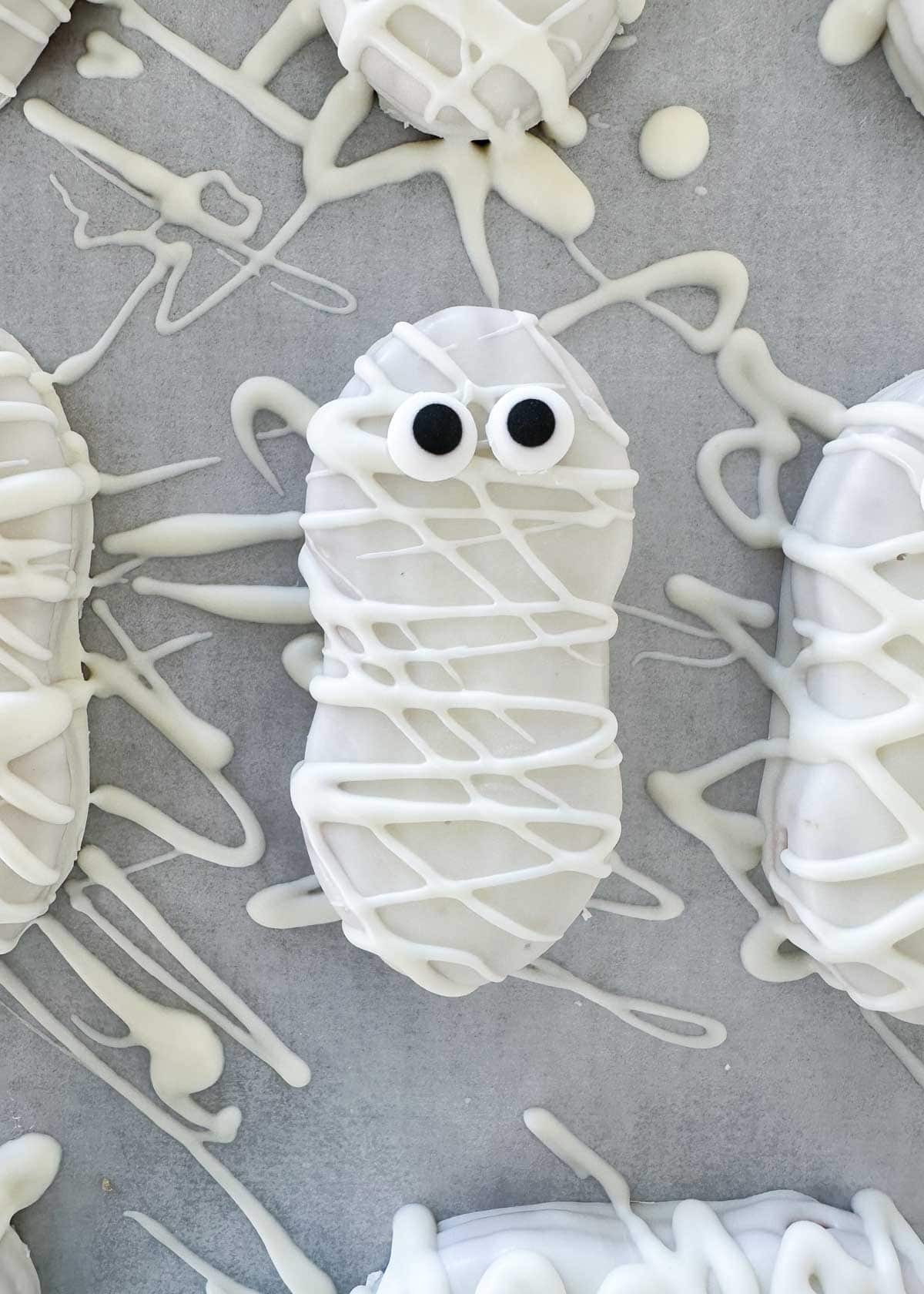 Showing how to make mummy cookies.