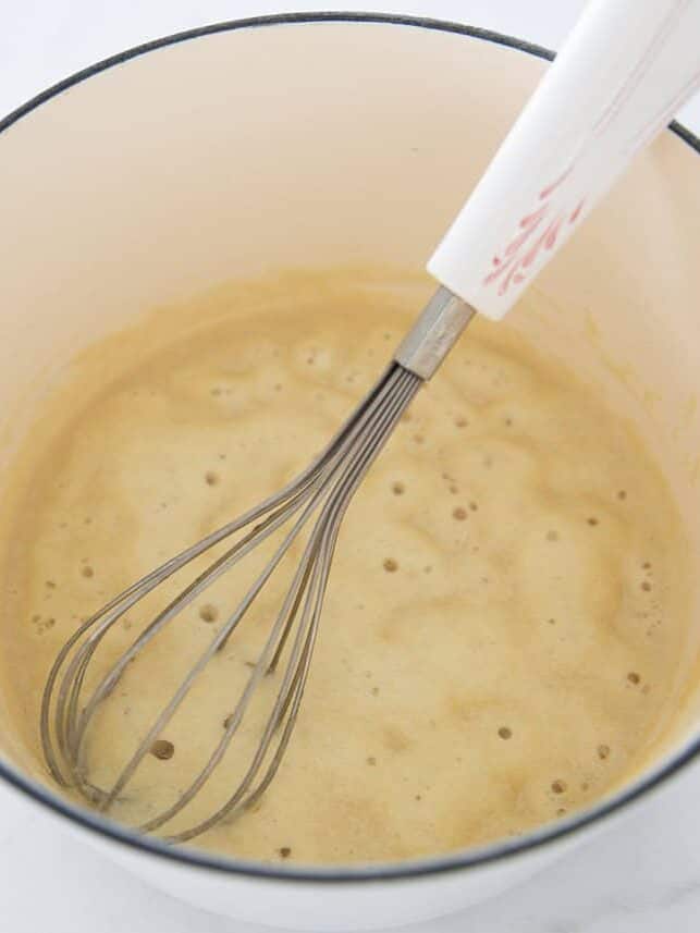 Flour and butter in a stove pot making a roux.