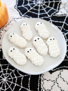 Mummy cookies on a plate.