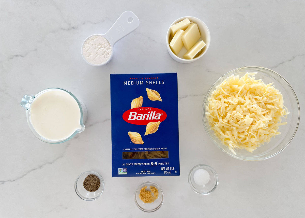 White cheddar cheese, milk, shells, dijon mustard, salt, pepper and butter.