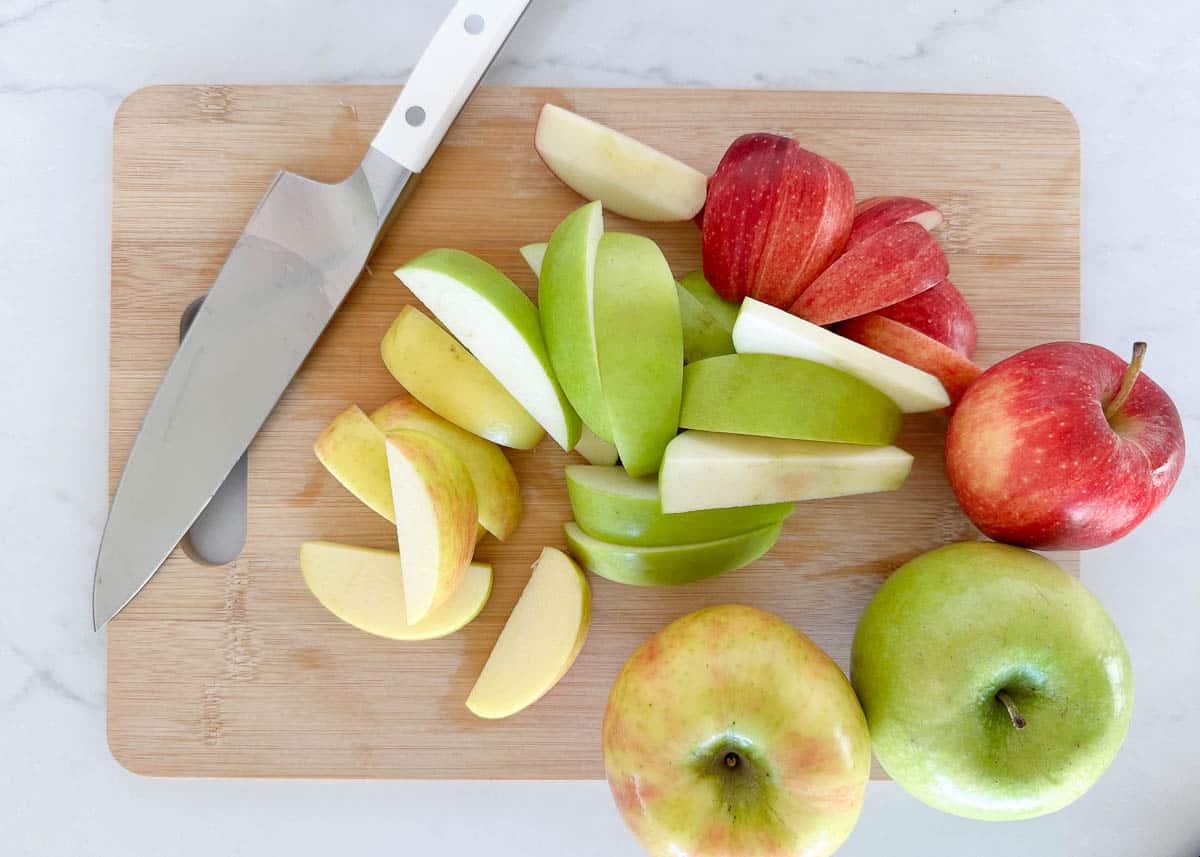 Sliced apples on cutting board.