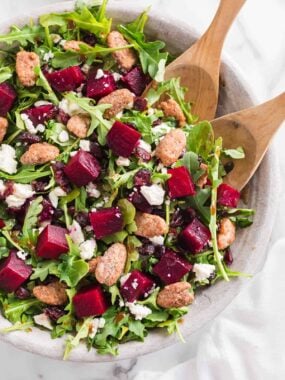 Beet salad with tongs.