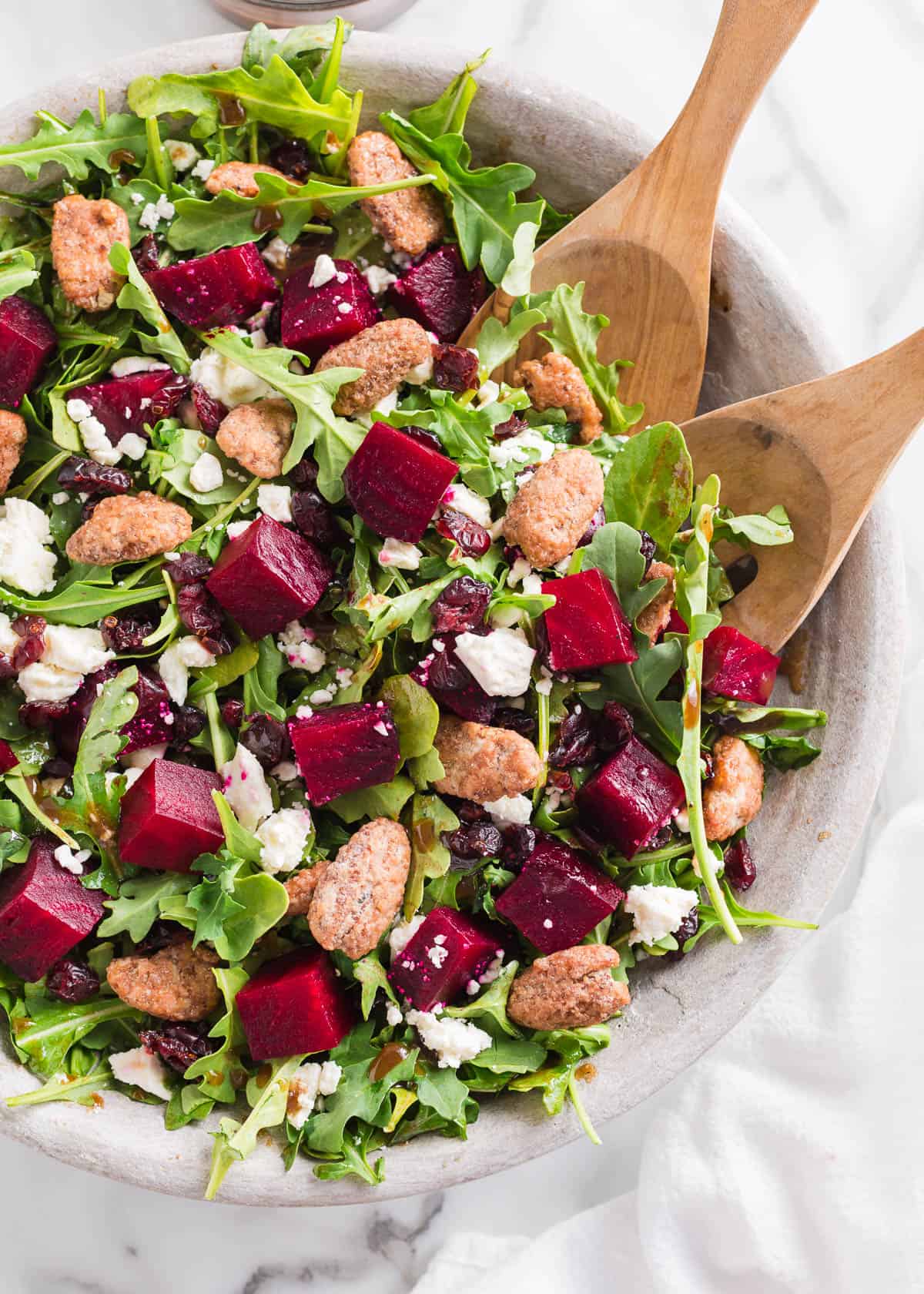 Beet salad with tongs.