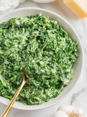 Creamed spinach in a white bowl.
