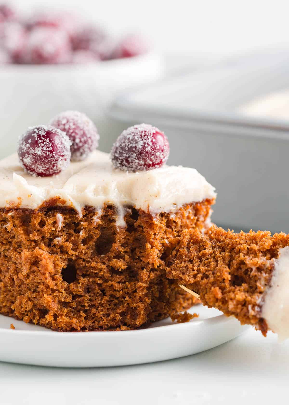 Slice of gingerbread cake with frosting.
