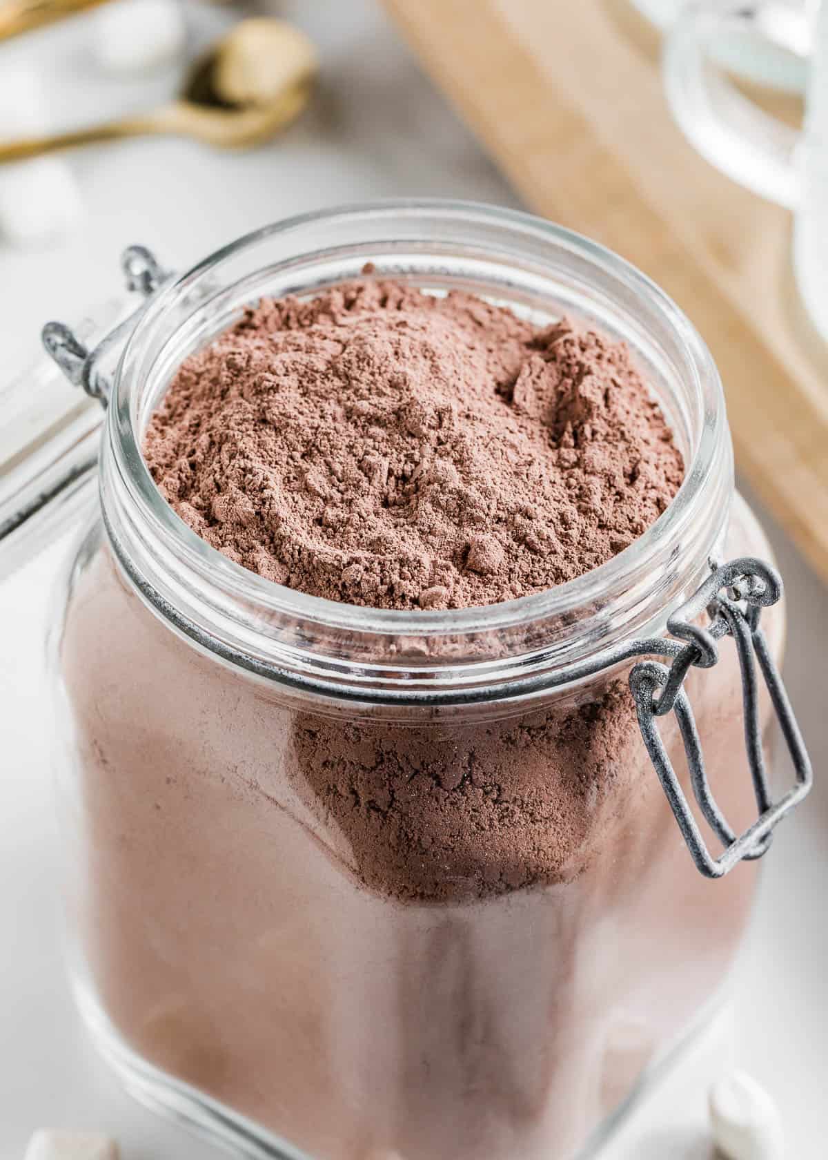 Make a large batch of this homemade hot chocolate mix to have on hand all winter season long. It's easy to make, tastes better than store bought and makes a festive gift! Jar full of homemade hot chocolate mix.