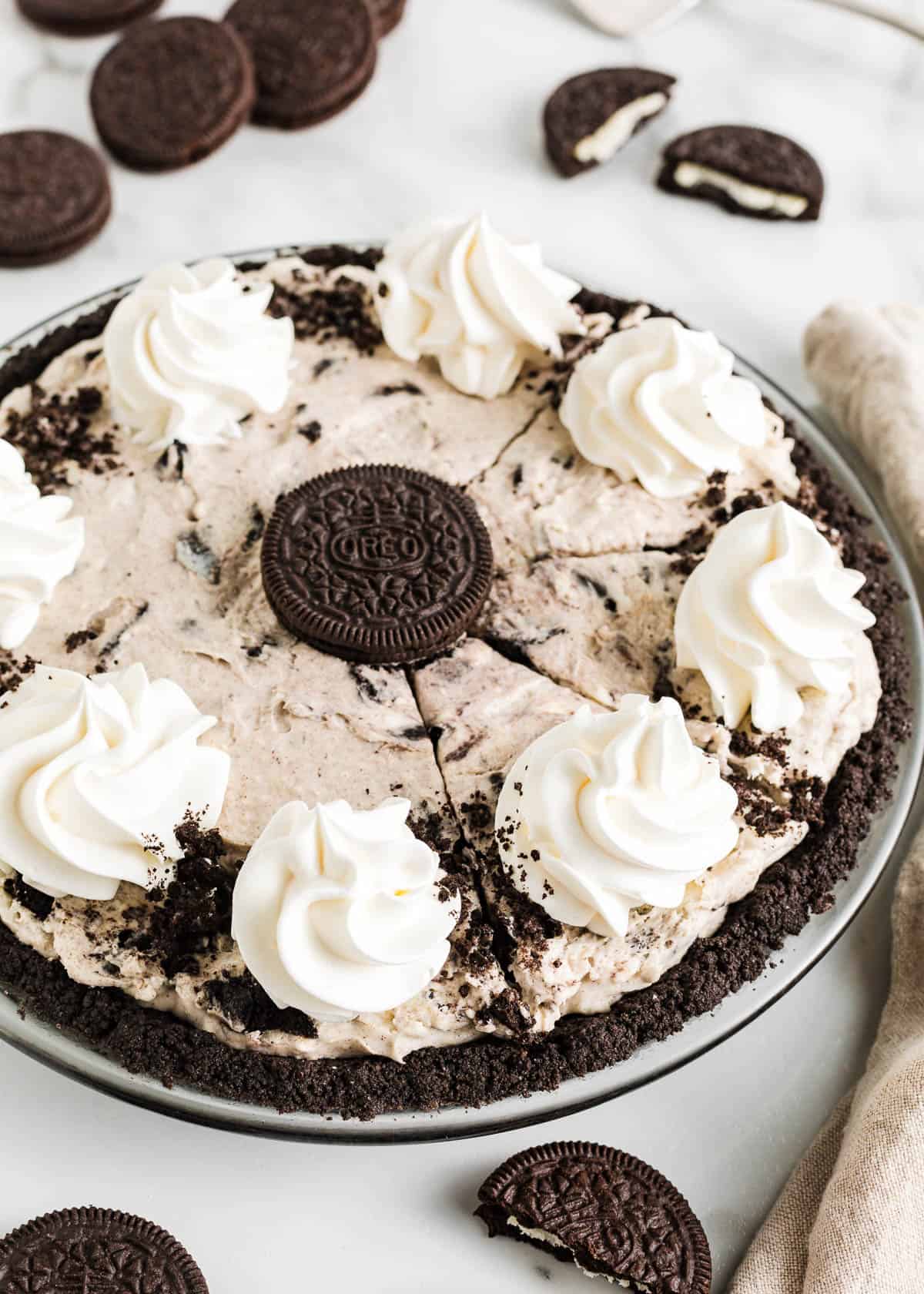 Made with a chocolaty Oreo cookie crust and a creamy Oreo cheesecake filling using simple ingredients, this easy no-bake Oreo pie sets up in the fridge in just a few hours! Sliced oreo pie.