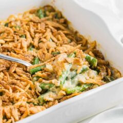 A southern green bean casserole inspired by Paul Deen's recipe in a white baking dish.