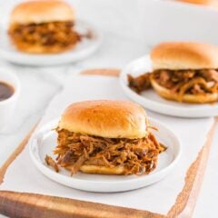 Pulled pork sliders on a plate.