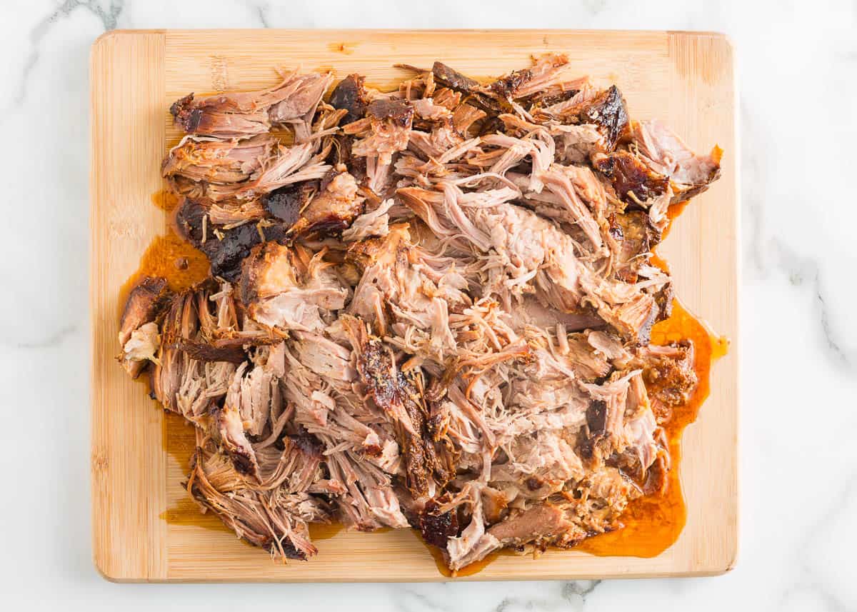 Pulled pork on a cutting board.