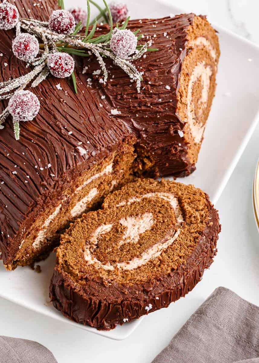 This Christmas make a traditional yule log cake (bûche de noël). A chocolate sponge cake is filled with creamy mascarpone, then covered with chocolate ganache for the bark. Slice of yule log cake.