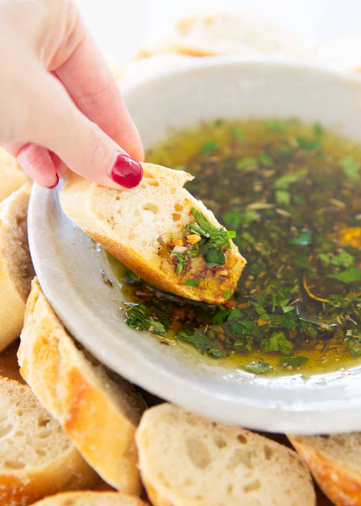 Dipping bread into bread dipping oil.