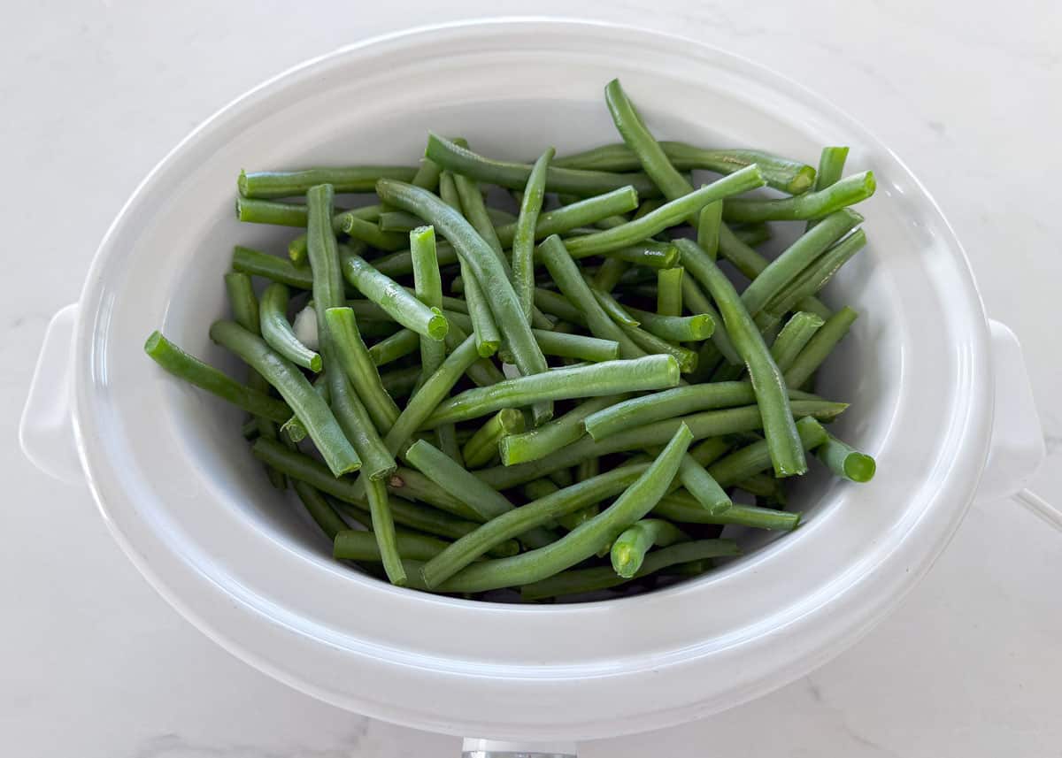 Green beans cooking in a crockpot.